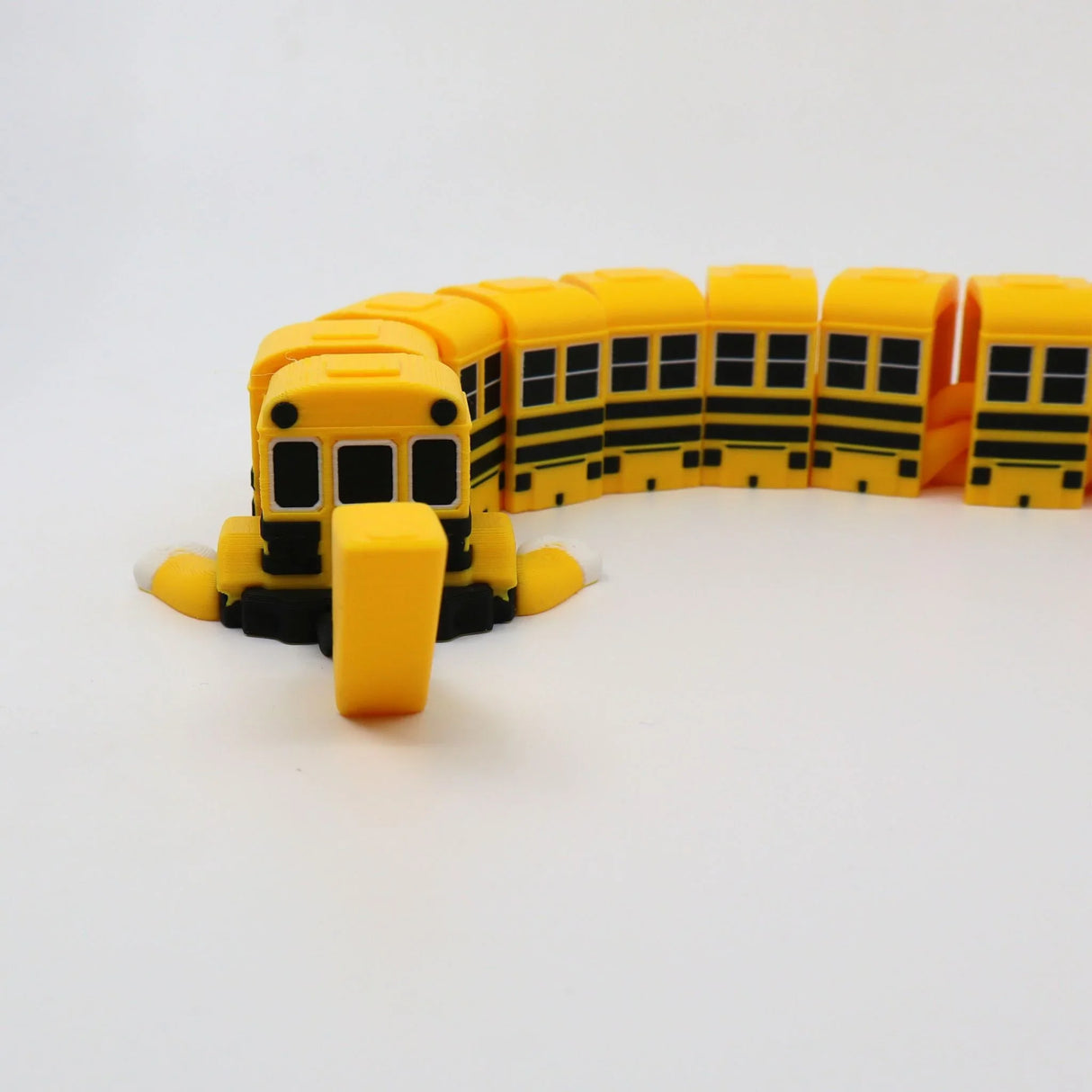 Yellow 3D printed school bus fidget toy with flexible segments for sensory play