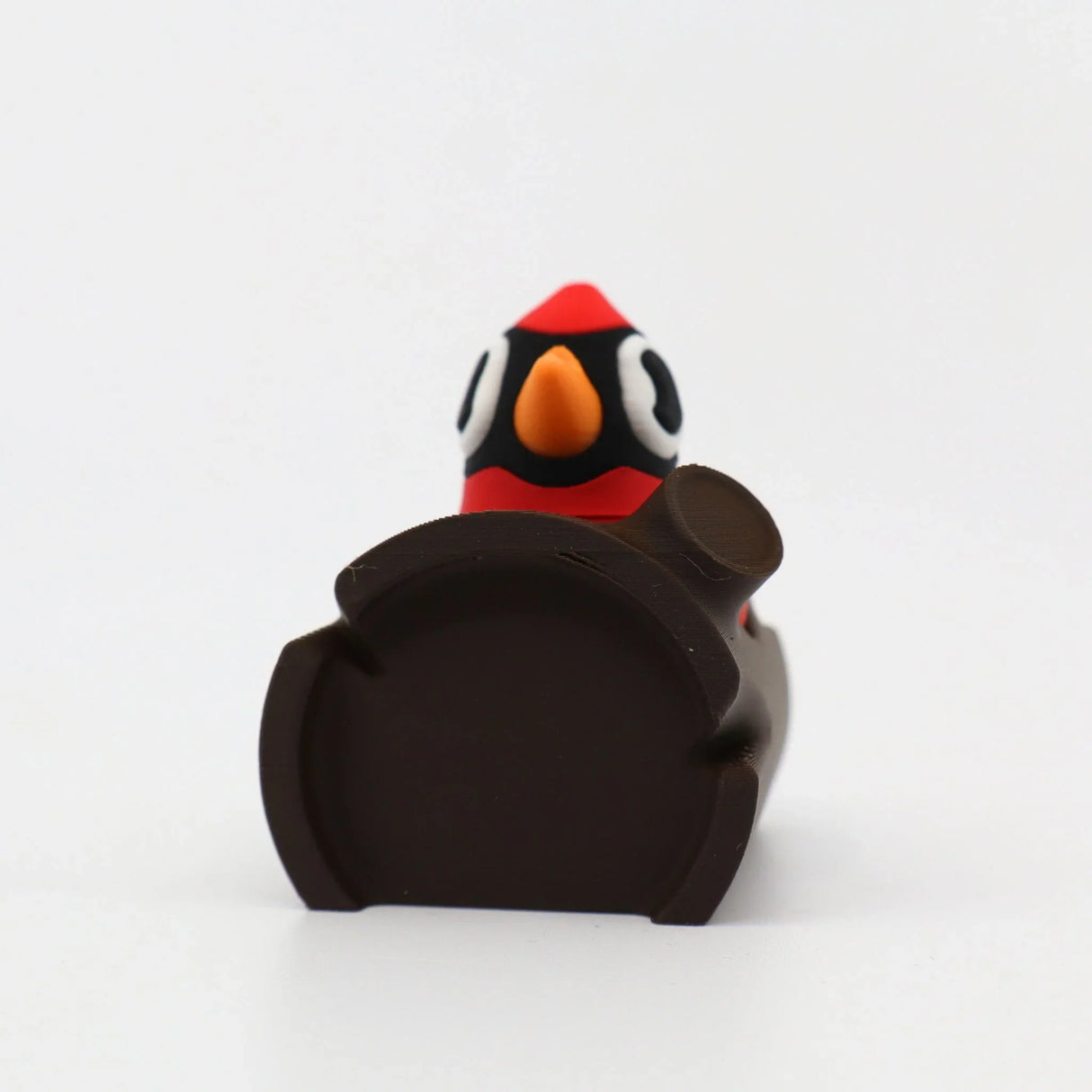 3D printed penguin fidget toy with red, black, white, and orange details for sensory play