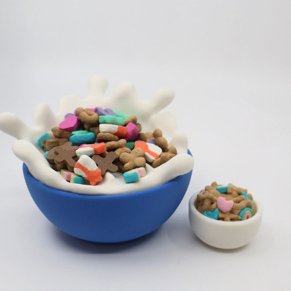 Colorful 3D printed sensory cereal toys in playful bowls on white background