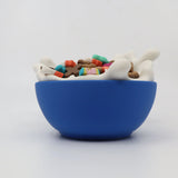 3D printed blue sensory toy bowl with colorful cereal pieces and playful milk splash design