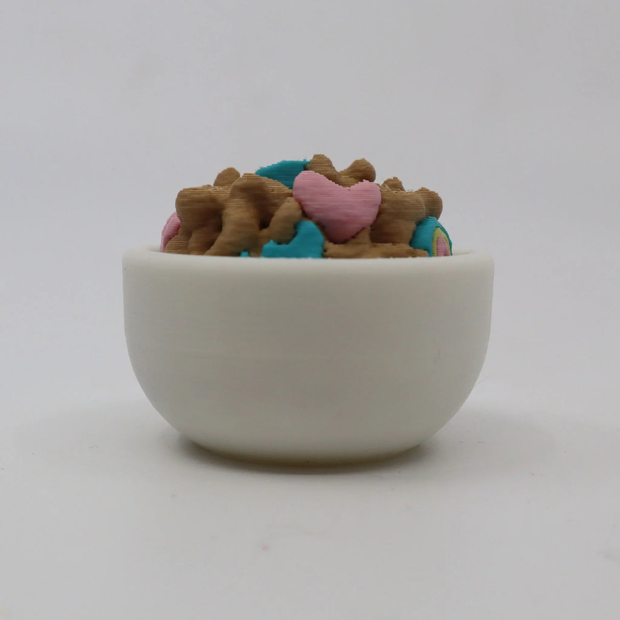 3D printed sensory toy bowl filled with colorful cereal-shaped pieces