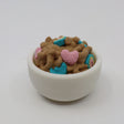 3D printed sensory toy shaped like cereal in a white bowl with colorful heart pieces