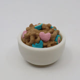 3D printed sensory toy shaped like cereal in a white bowl with colorful heart pieces