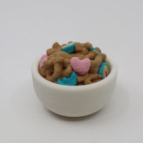3D printed sensory toy shaped like cereal in a white bowl with colorful heart pieces