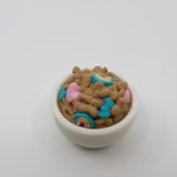 3D printed sensory cereal toy in a white bowl with colorful blue and pink details