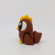 Brown 3D printed sensory chicken toy with yellow details on a white background