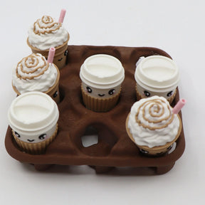 3D printed coffee cup and whipped cream pieces on a brown tic-tac-toe sensory game board