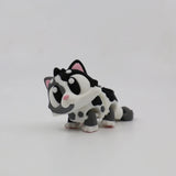 3D printed black and white cat sensory toy with large eyes and flexible joints