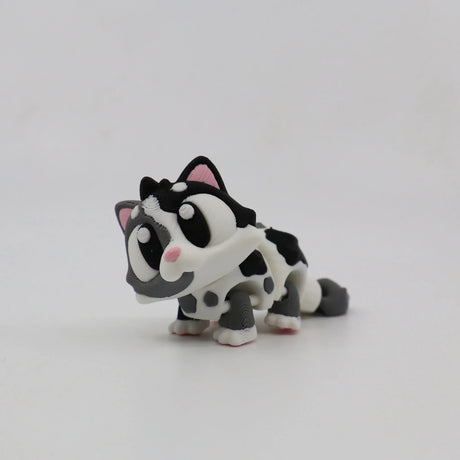 3D printed black and white cat sensory toy with large eyes and flexible joints