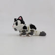 3D printed sensory toy cat with black and white spots on a plain white background