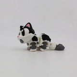 3D printed sensory toy cat with black and white spots on a plain white background