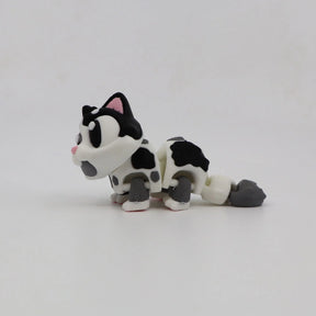 3D printed sensory toy cat with black and white spots on a plain white background