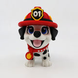 3D printed fire pup fidget toy with red helmet, blue eyes, and flame badge for sensory play