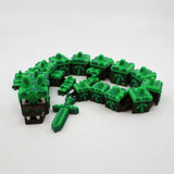 Pixelated green dragon fidget toy with blocky segments and sword, 3D printed sensory tool for kids