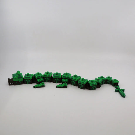 Pixelated green and brown 3D printed flexi dragon toy for sensory play and fidgeting