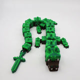 Pixelated green 3D printed alligator fidget toy with flexible segments and matching sword for sensory play