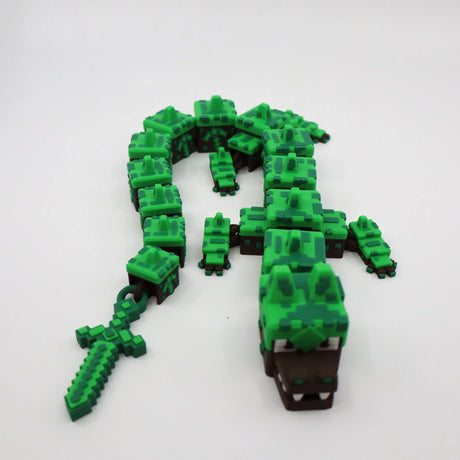 Pixelated green 3D printed alligator fidget toy with flexible segments and matching sword for sensory play