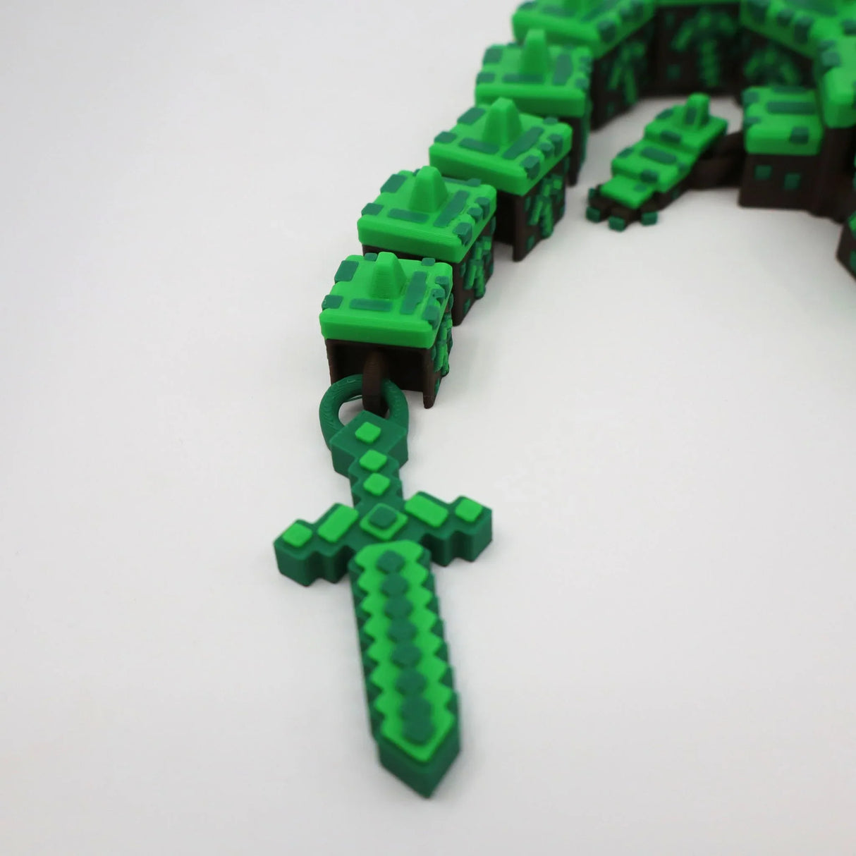 3D printed pixelated green sword and block chain fidget toy for sensory play