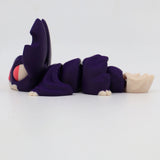Purple 3D printed sensory toy caterpillar with segmented body and large eyes on white background