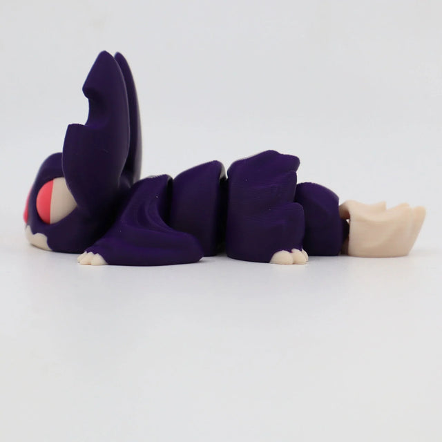Purple 3D printed sensory toy caterpillar with segmented body and large eyes on white background