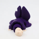 Purple 3D printed sensory toy shaped like a lizard with beige face on white background
