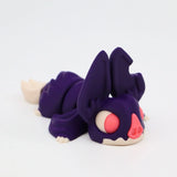 Purple 3D printed sensory toy animal with large ears and pink eyes, on white background