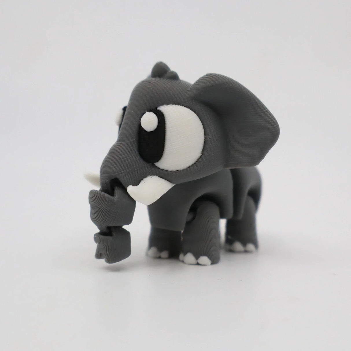 3D printed gray elephant sensory toy with large eyes on a white background
