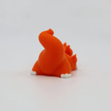 Orange 3D printed flexi dinosaur toy for sensory play and fidgeting