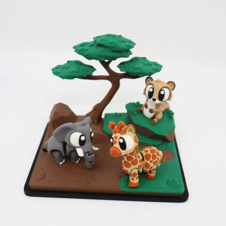 3D printed sensory toy with cute giraffe, elephant, and meerkat figures under a tree