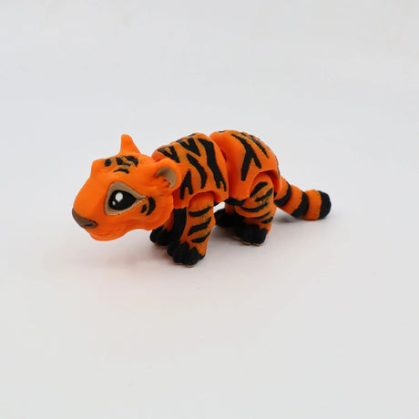 3D printed orange tiger fidget toy with black stripes on a white background