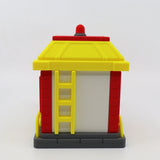 3D printed fire station toy with yellow roof, red walls, and ladder for sensory play