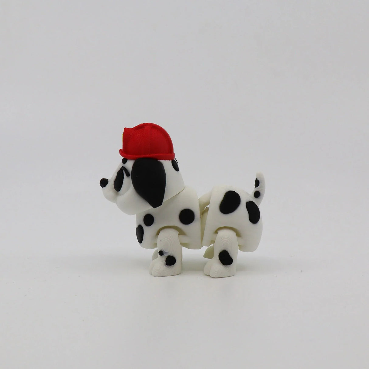 3D printed Dalmatian fidget toy with red hat, sensory-friendly flexi animal for kids