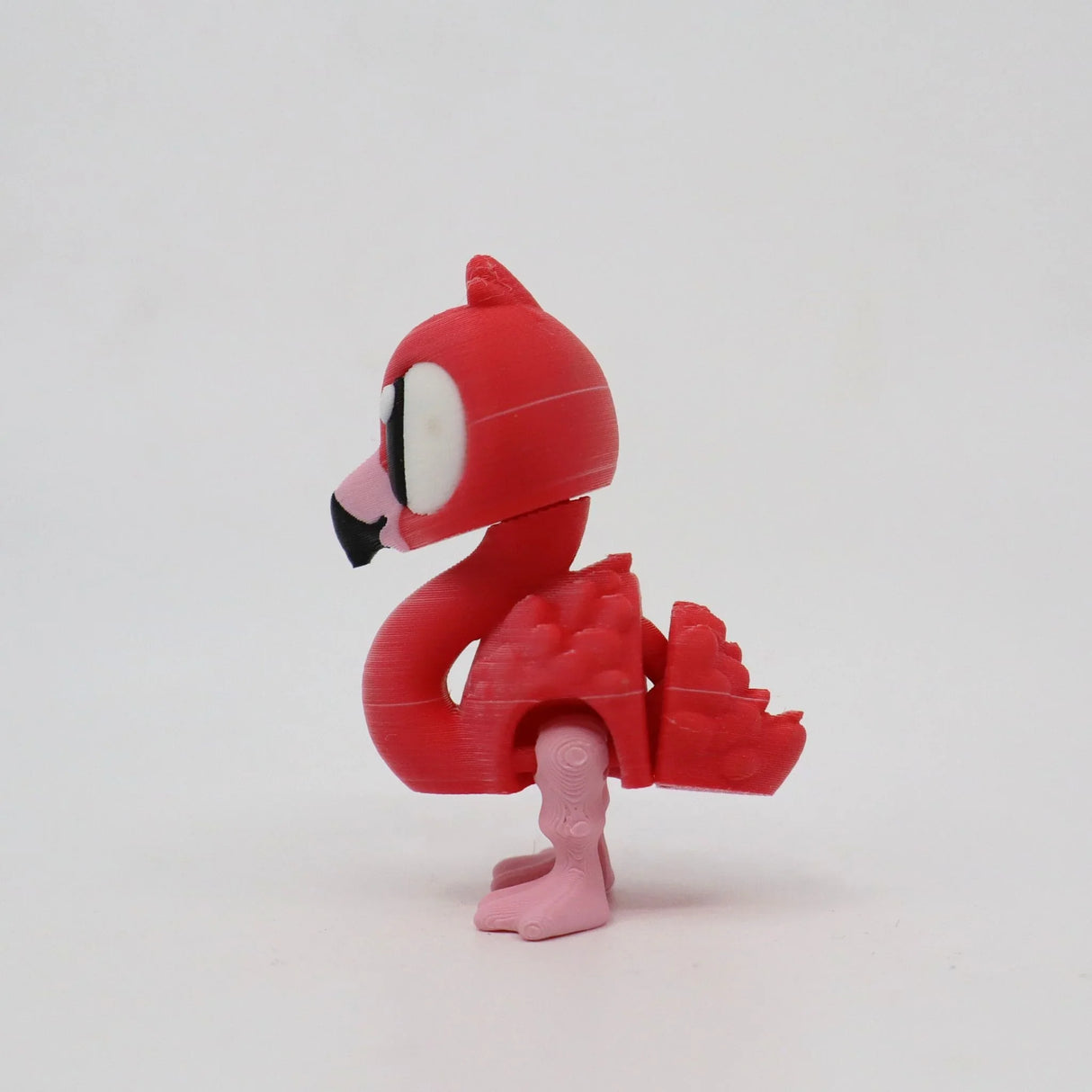 3D printed pink flamingo sensory fidget toy with large eyes on white background