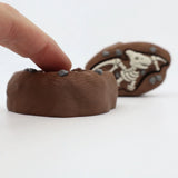 3D printed dinosaur fossil sensory toy with textured surface and embedded stones