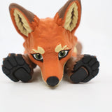 3D printed orange fox sensory toy with textured paws and lifelike eyes on white background.