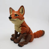 3D printed orange fox sensory toy with flexible joints on white background
