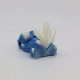 Blue and white 3D printed sensory dinosaur toy with crystal-like spikes on a white background.