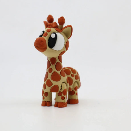 3D printed sensory giraffe toy with large eyes and orange spots on white background