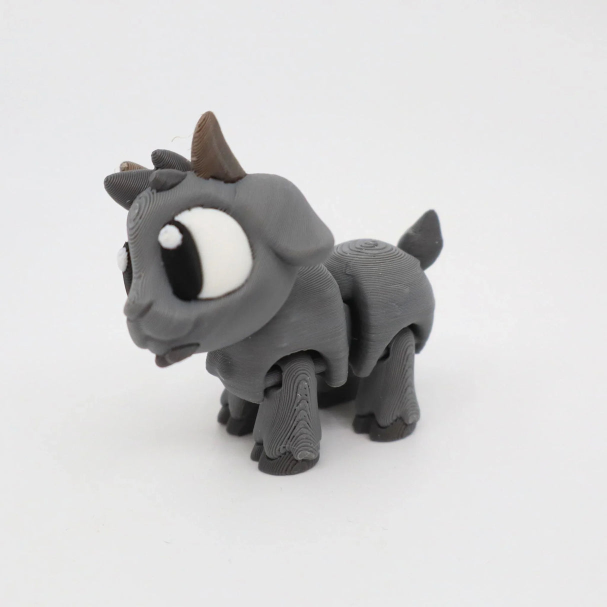 Gray 3D printed goat sensory toy with large eyes on a white background