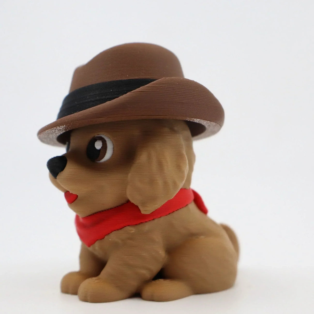 3D printed puppy fidget toy with brown hat and red bandana, sensory-friendly design for kids