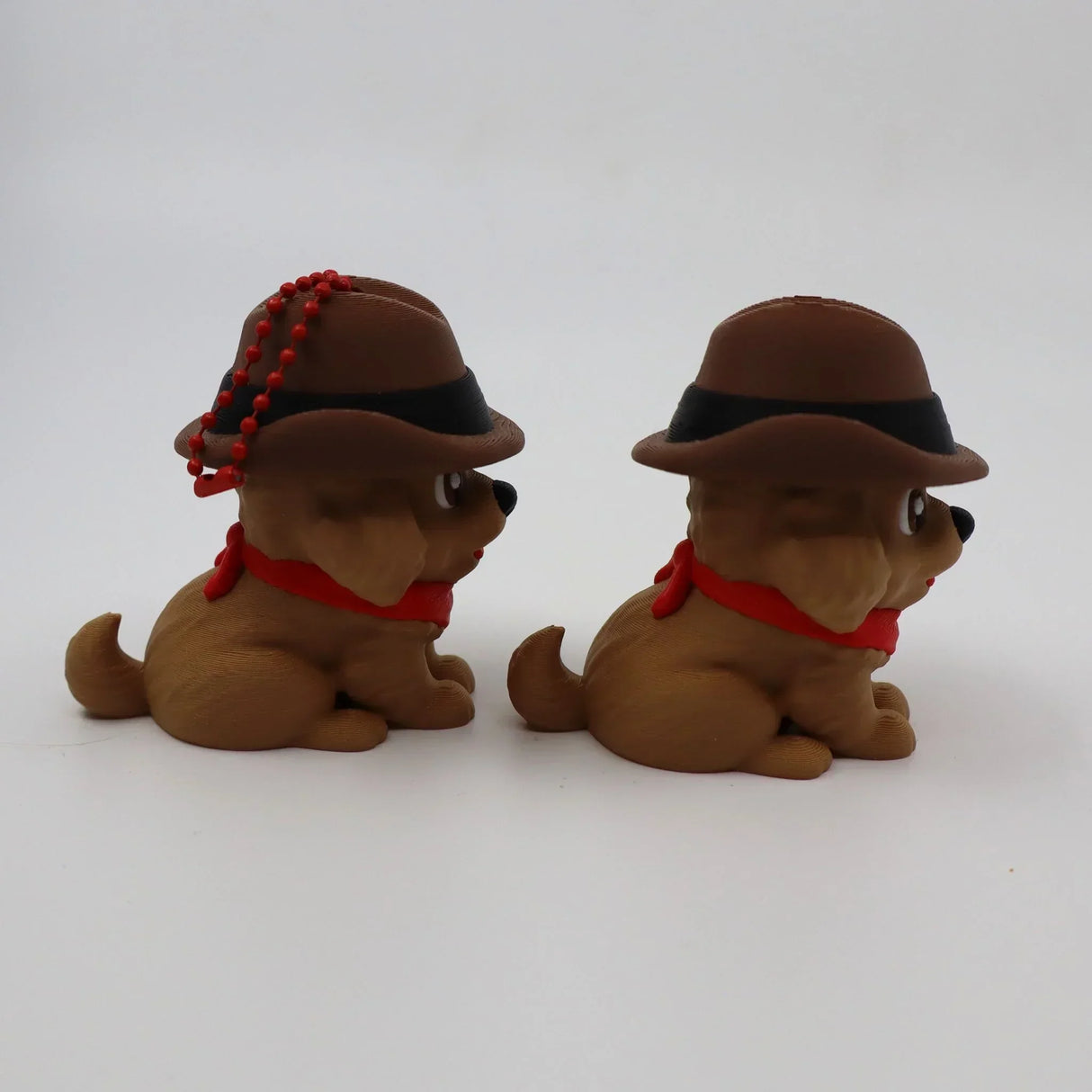 3D printed sensory dog toys with hats and red scarves for tactile play