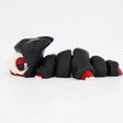 3D printed black and red segmented sensory toy caterpillar with hood, fidget toy on white background