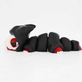 3D printed black and red segmented sensory toy caterpillar with hood, fidget toy on white background