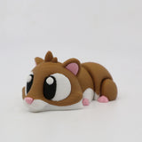 Cute 3D printed hamster sensory toy with large eyes, brown and white body, pink ears and nose