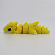 Yellow 3D printed flexi dragon fidget toy for sensory play and tactile stimulation