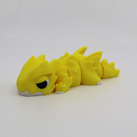 Yellow 3D printed flexi dragon fidget toy for sensory play and calming stimulation