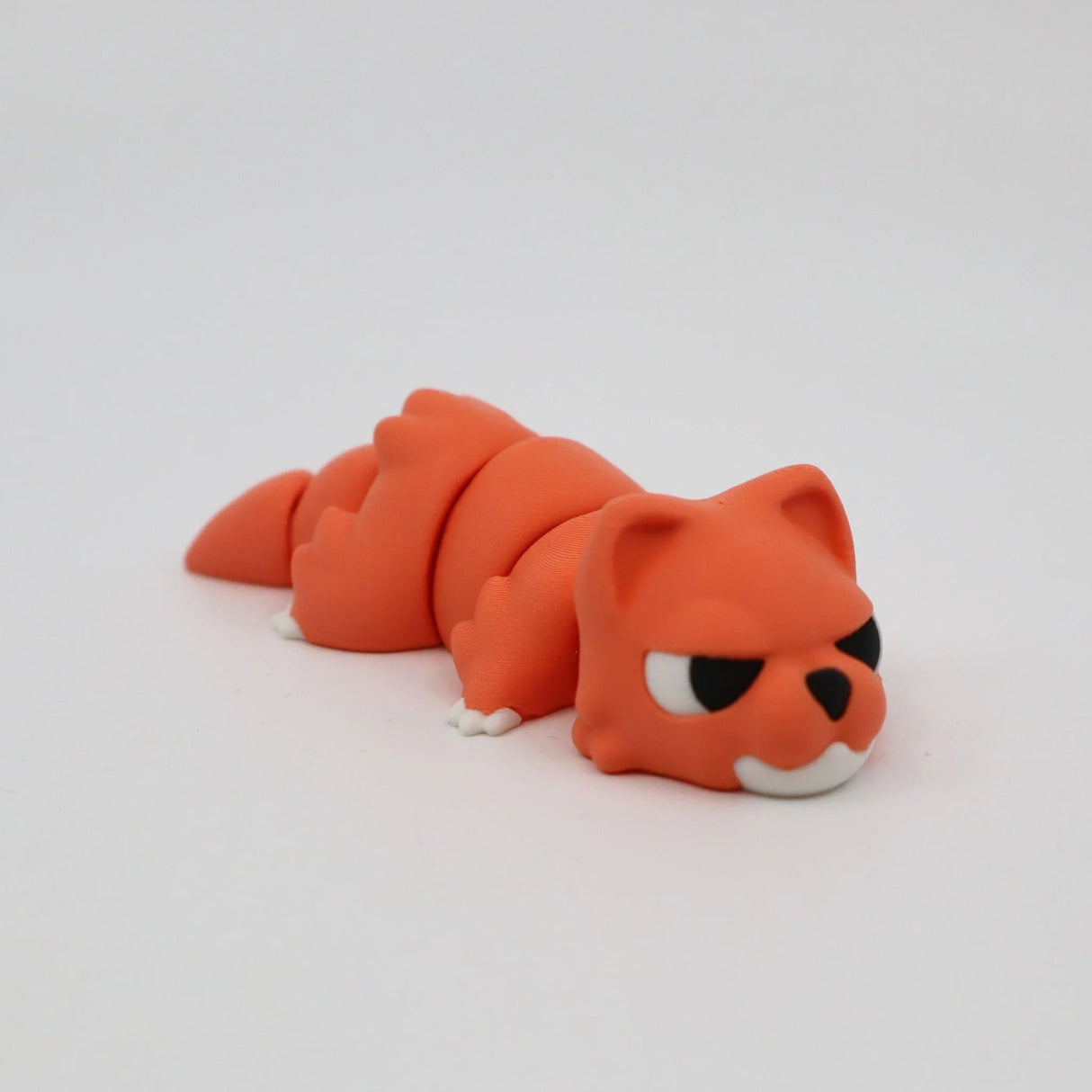 Orange 3D printed flexi animal sensory toy with cartoon fox features on white background