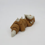 3D printed brown and white sensory toy resembling a segmented, horned creature on white background