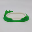 3D printed sensory toy base shaped like a white pond with green grass details