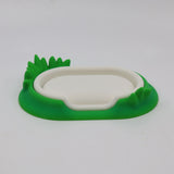 3D printed sensory toy base shaped like a white pond with green grass details